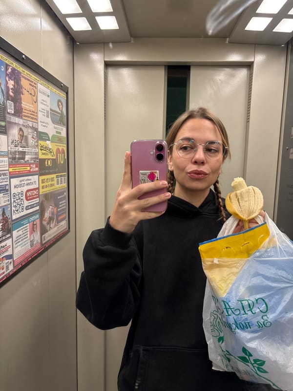 Woman takes elevator selfie while holding banana in Ust-Ilimsk