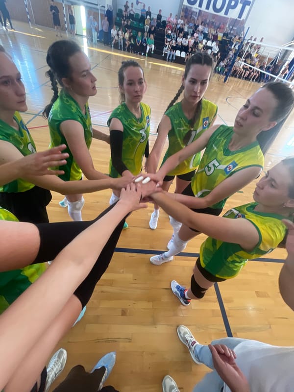Volleyball match and team huddles at a Sharkan gymnasium