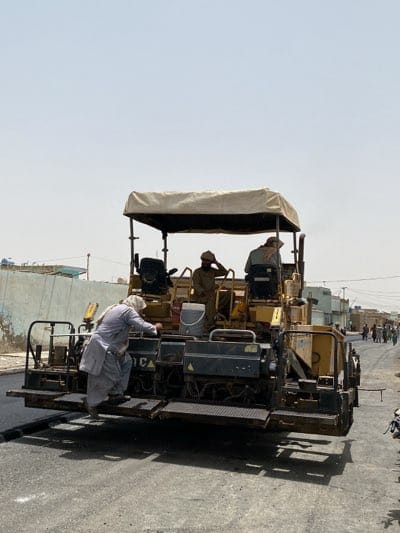 Road paving operations underway in residential Kandahar neighborhood