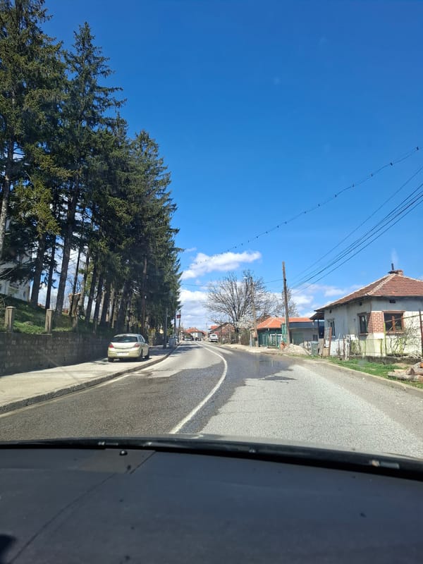 Vehicle passes through rural Barziya, Bulgaria on spring morning