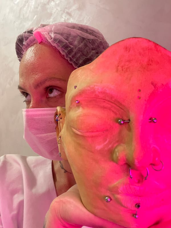 Healthcare worker takes selfies in pink protective gear