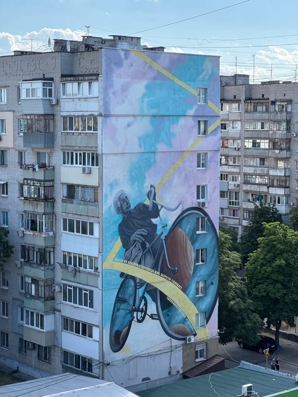 Street mural, open skies, and a cat in Slobozhanske