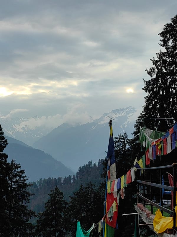 Deck hangout in Manali with Himalayan peaks as backdrop