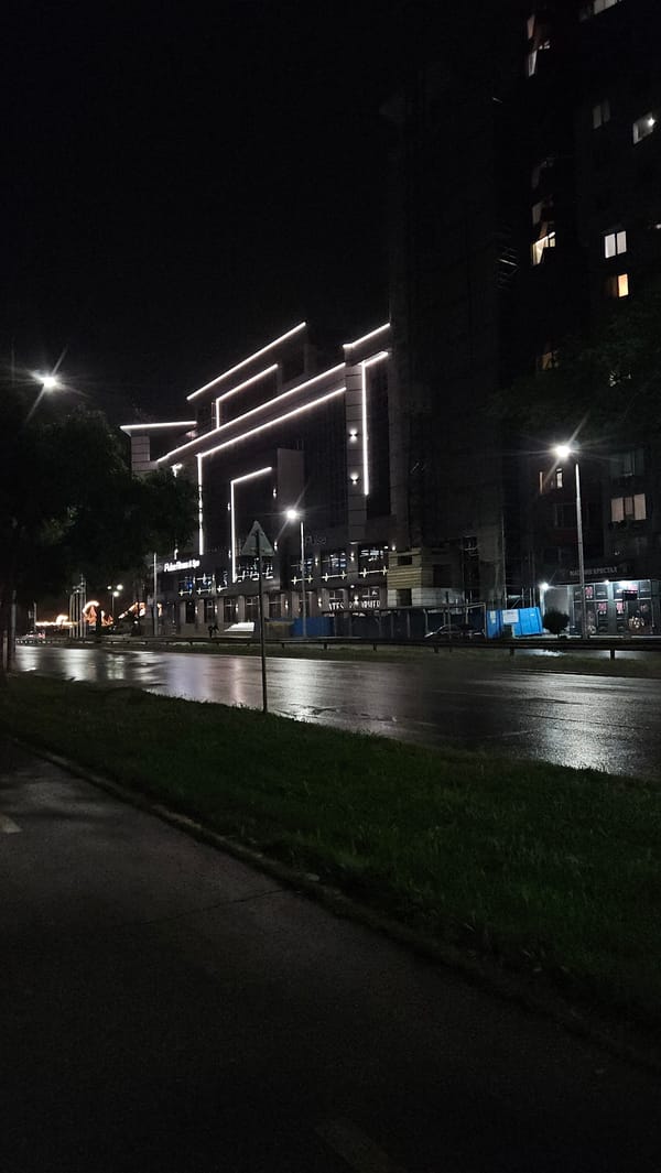 Rainy night scene captured on Plovdiv street with reflective pavement