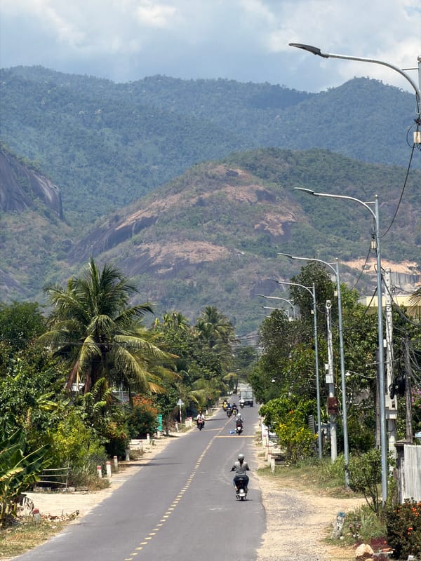 Morning traffic flows on mountain road in Diên Thọ, Vietnam