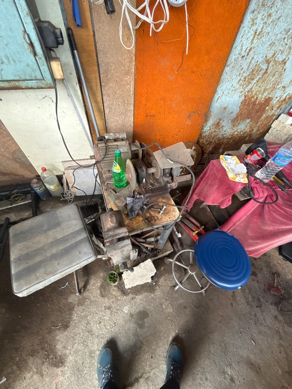 Cluttered garage with open silver sedan documented in Zlatograd