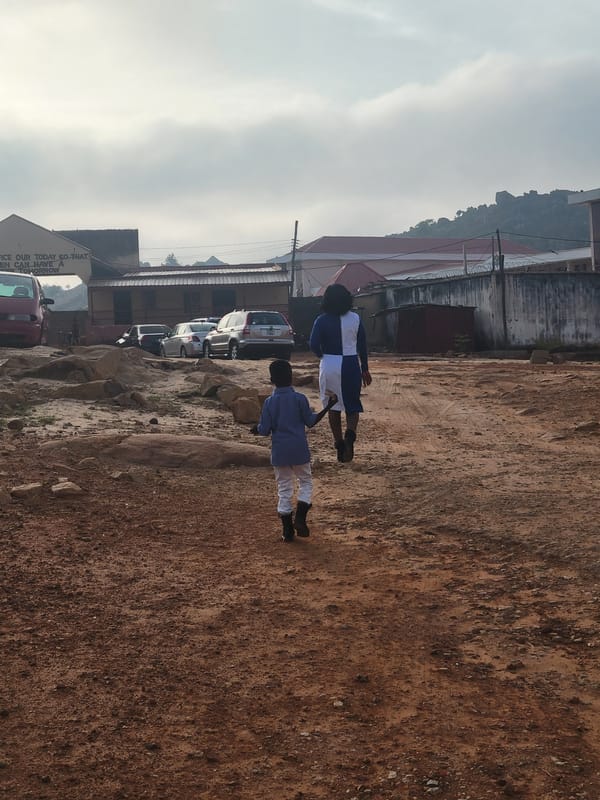 Two people walk on rocky ground in Gura Top