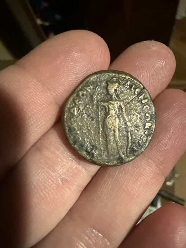 Person examines coin and decorative Nokia phone in Bulgaria