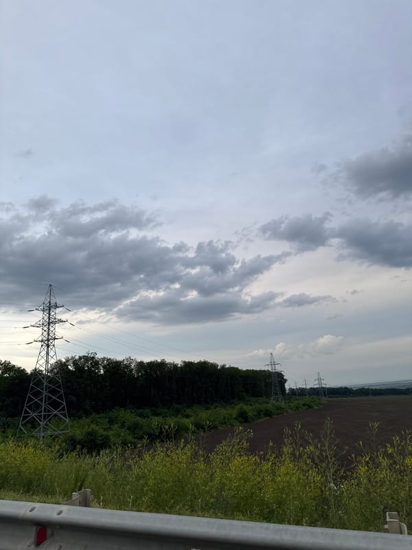 Driving through Stavropol under a stormy golden-hour sky
