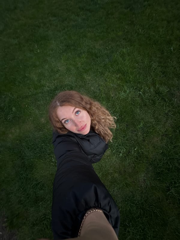 Woman photographs herself among spring daffodils in Russian garden