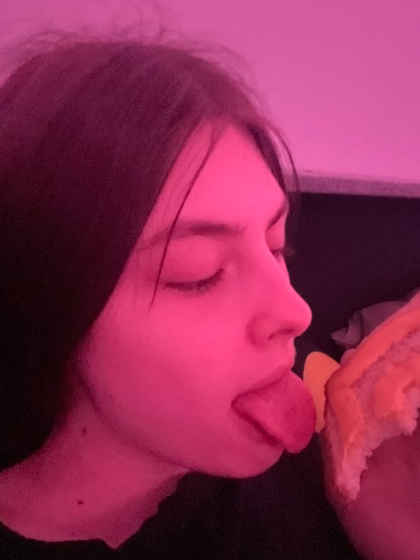 Person observed under pink lighting in Saint Petersburg evening