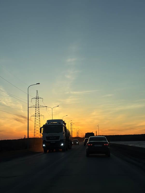 Evening traffic flows through Chaikovsky as daylight fades