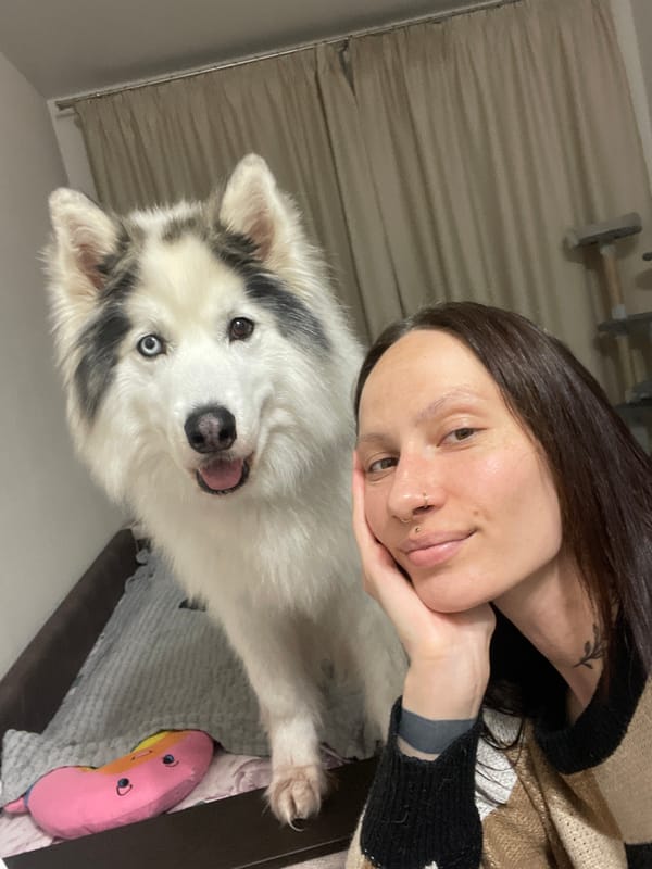 Woman poses with heterochromatic dog in Izhevsk