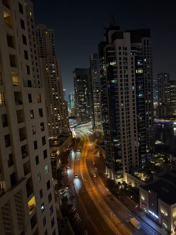 Nighttime aerial views capture illuminated Dubai Marina district evening scene