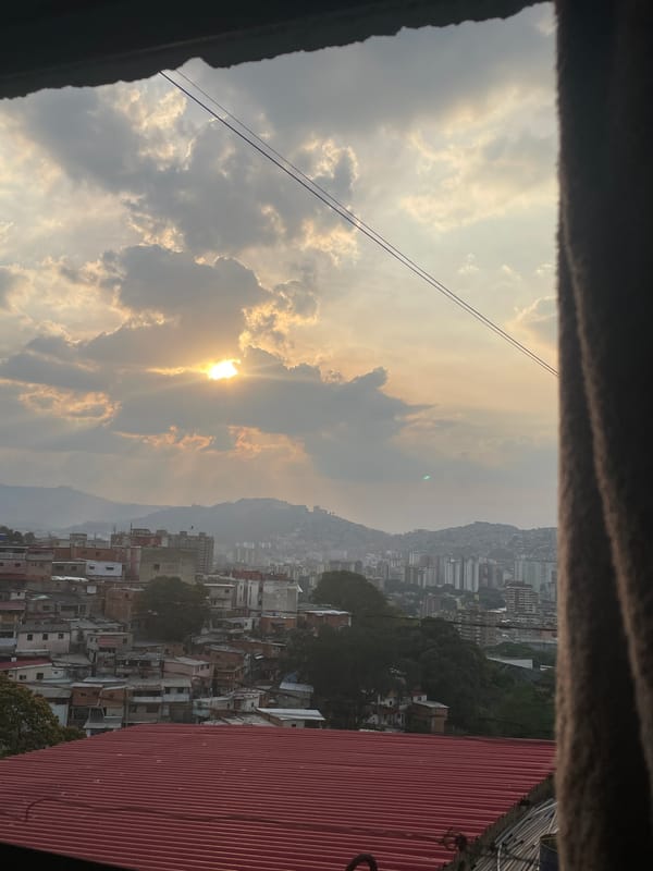 Hazy sunset photographed over Caracas hillside neighborhood