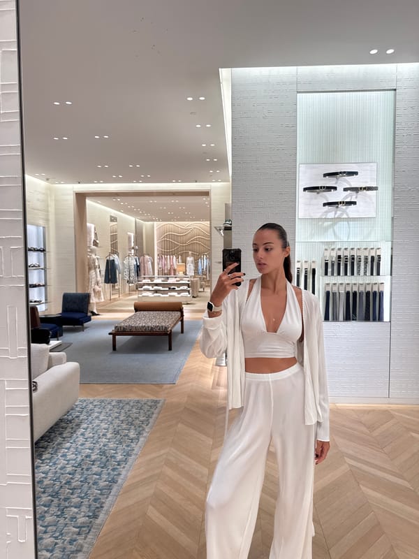Woman takes mirror selfie at retail store in Thailand