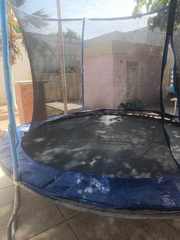 Children play on backyard trampoline in Porlamar, Venezuela
