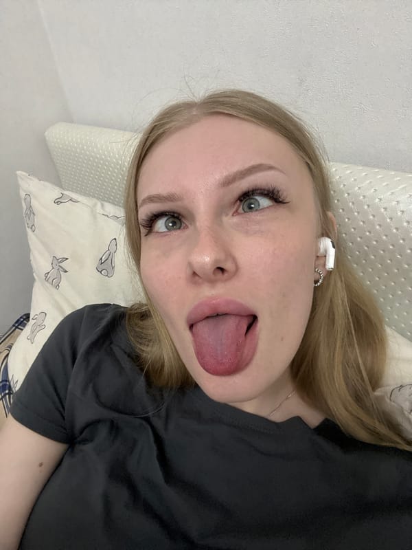 Relaxing at home in Perm, earbuds in, taking it easy