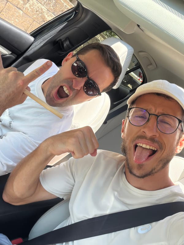Two men take selfie in car in Tel Aviv