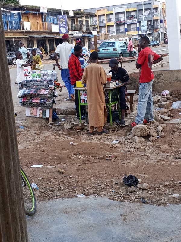 Street vendors and pedestrians moving through central Jos