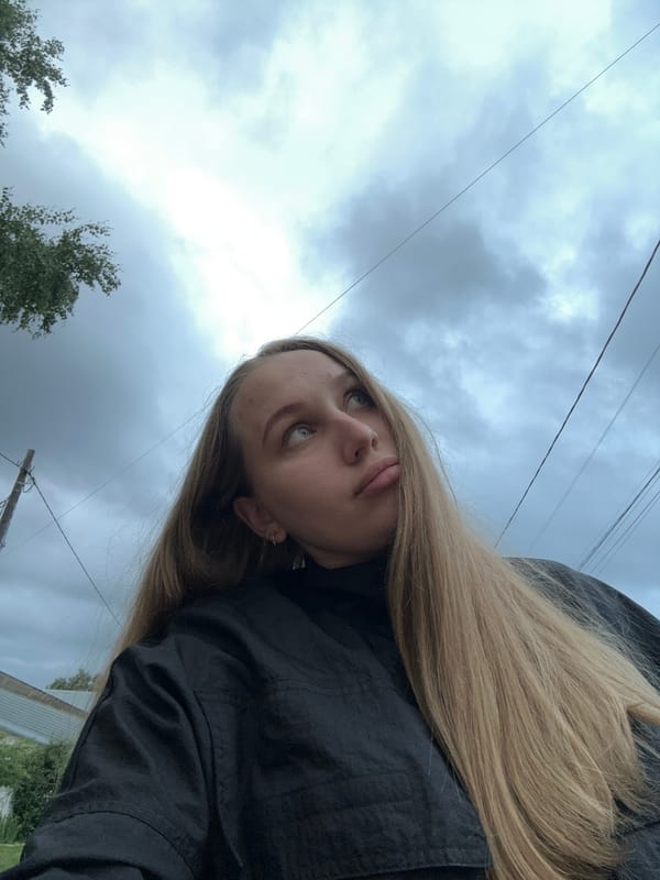 Woman photographs herself outdoors in Chaikovsky, Russia