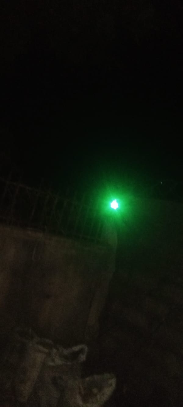 Person operates green laser pointer in Nigerian neighborhoods at night