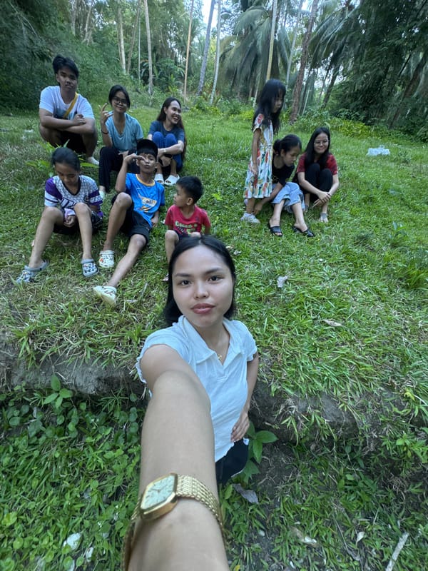 Family group gathers near tropical stream in Kiblawan