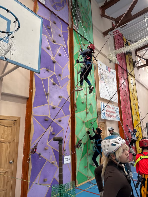 Climbers practice at indoor gym with colorful walls