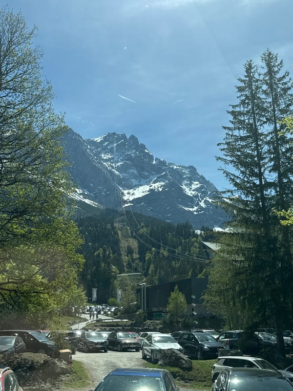 Cable cars spotted against snow-covered Zugspitze in Grainau