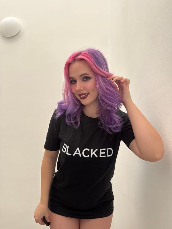 Woman with pink-purple hair photographs self in Zagreb residence