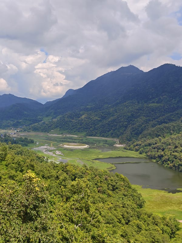 Pokhara morning: lakeside views, a Hanuman statue, and prayer flags