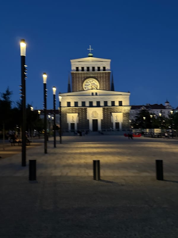 Prague's Vinohrady church lit up at dusk
