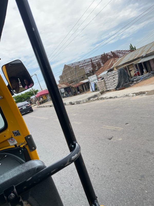Street life and roadside commerce across a busy Jalingo morning