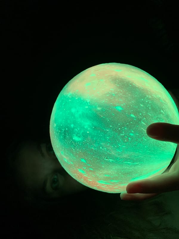 Person holds glowing orbs in nighttime Chaikovsky, Russia