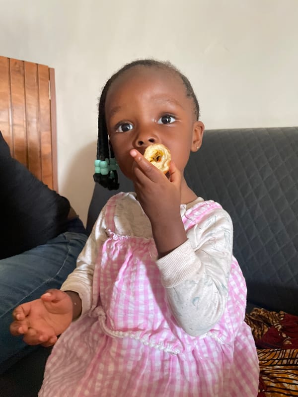 Young girl photographed with family member in Nigeria home