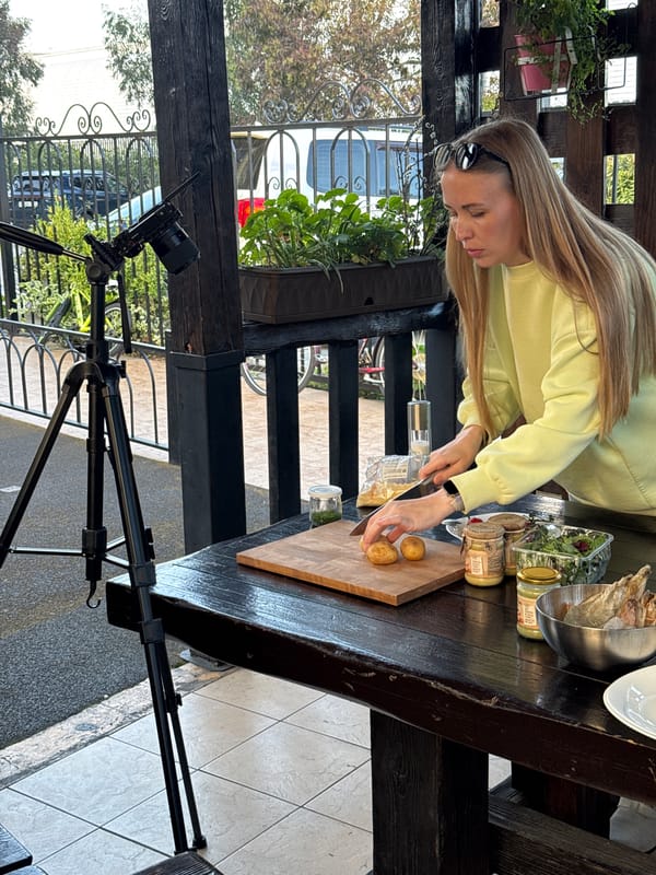 Woman grills seafood outdoors in Sirius, Russia