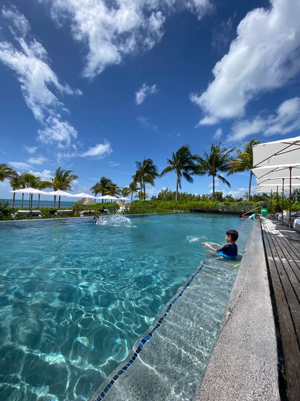 Resort guests enjoy poolside leisure at Marina Maroma Mexico