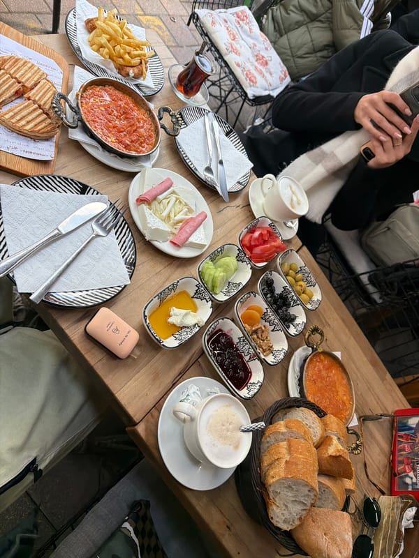 Couple enjoys traditional Turkish breakfast at Istanbul outdoor cafe