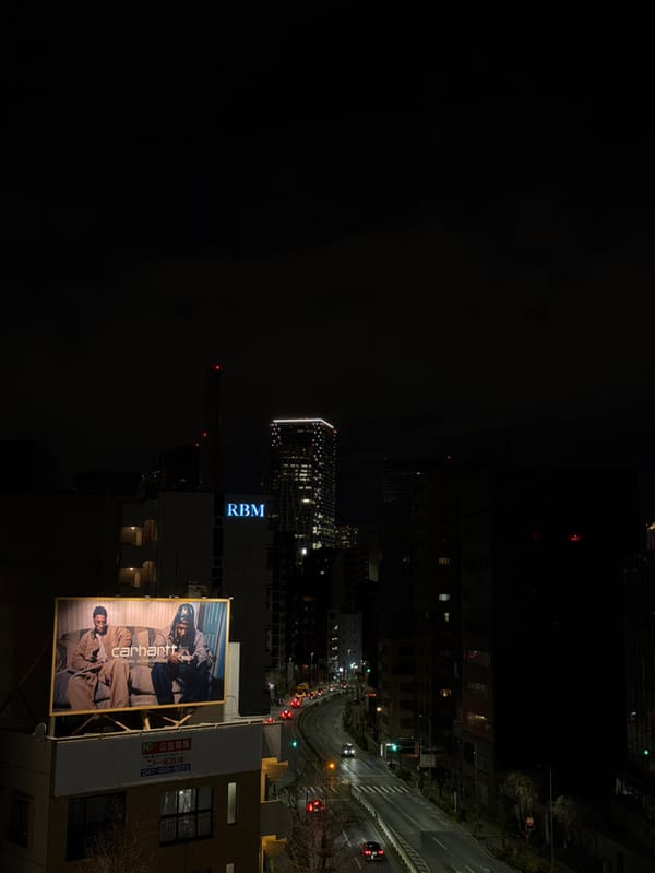Aerial nighttime view captured over Shibuya streets from elevation