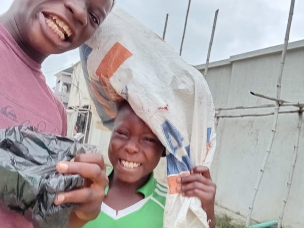 Two kids clowning around in a selfie session outdoors