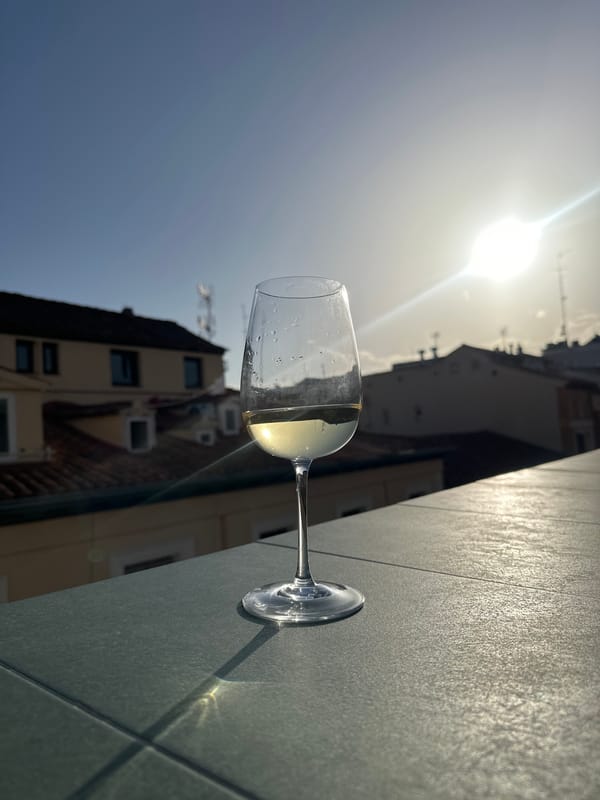 Nearly empty wine glass photographed on Madrid terrace