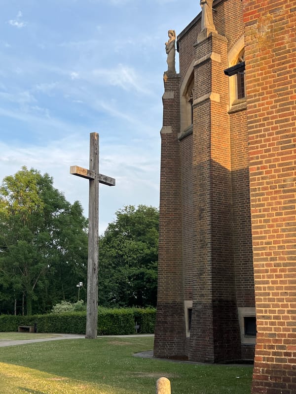 Wooden cross outside a brick building in Guildford