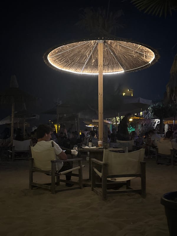 Night out at a lit-up beachside bar with quirky murals