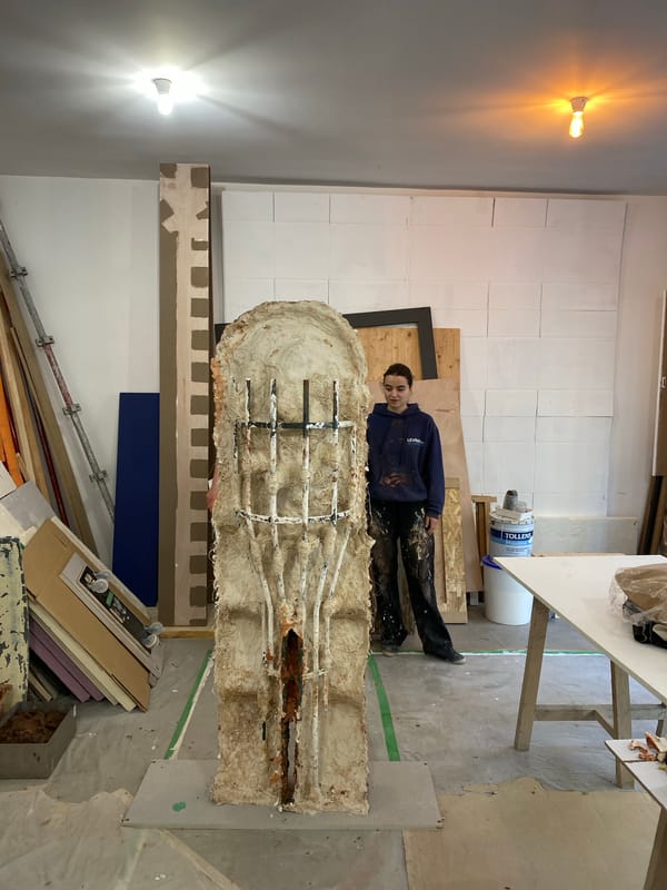 Artists work on large sculpture in Paris studio