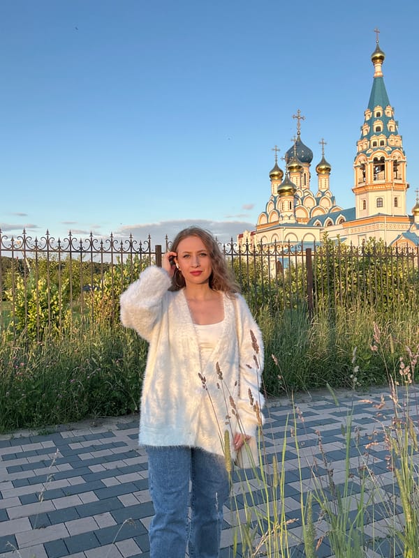 Casual moment on a Moscow walkway, hand raised to ear