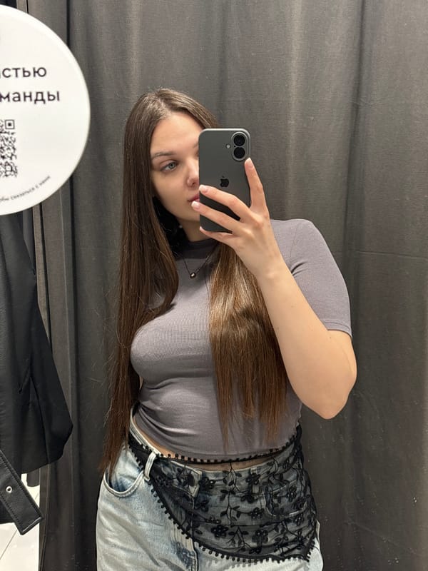 Person tries on clothes, takes mirror selfies in Yekaterinburg dressing room