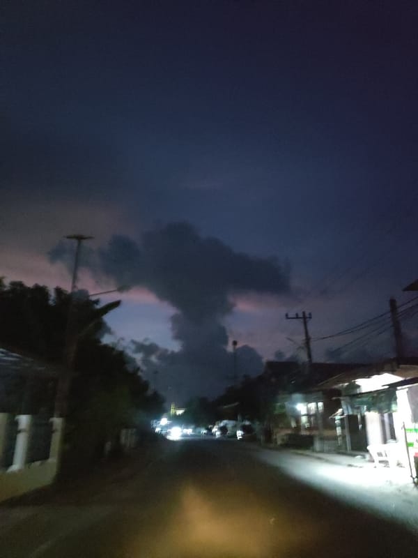 Nighttime street scene captured in residential Lhokseumawe, Indonesia