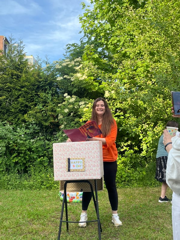 Woman with book and gift enjoys outdoor moment in Saarbrücken