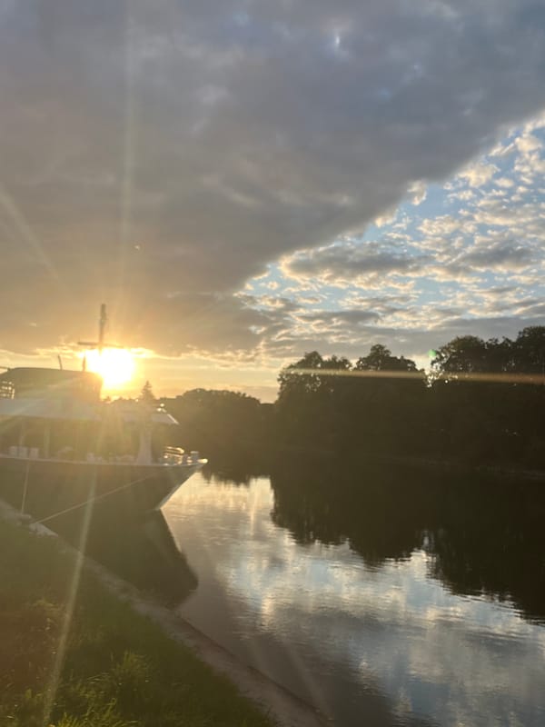 Golden sunset over the Danube with a docked ship in Regensburg