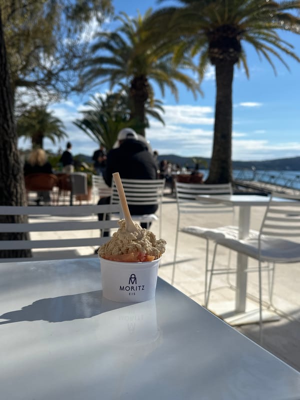 Woman enjoys gelato at waterfront cafe in Tivat, Montenegro